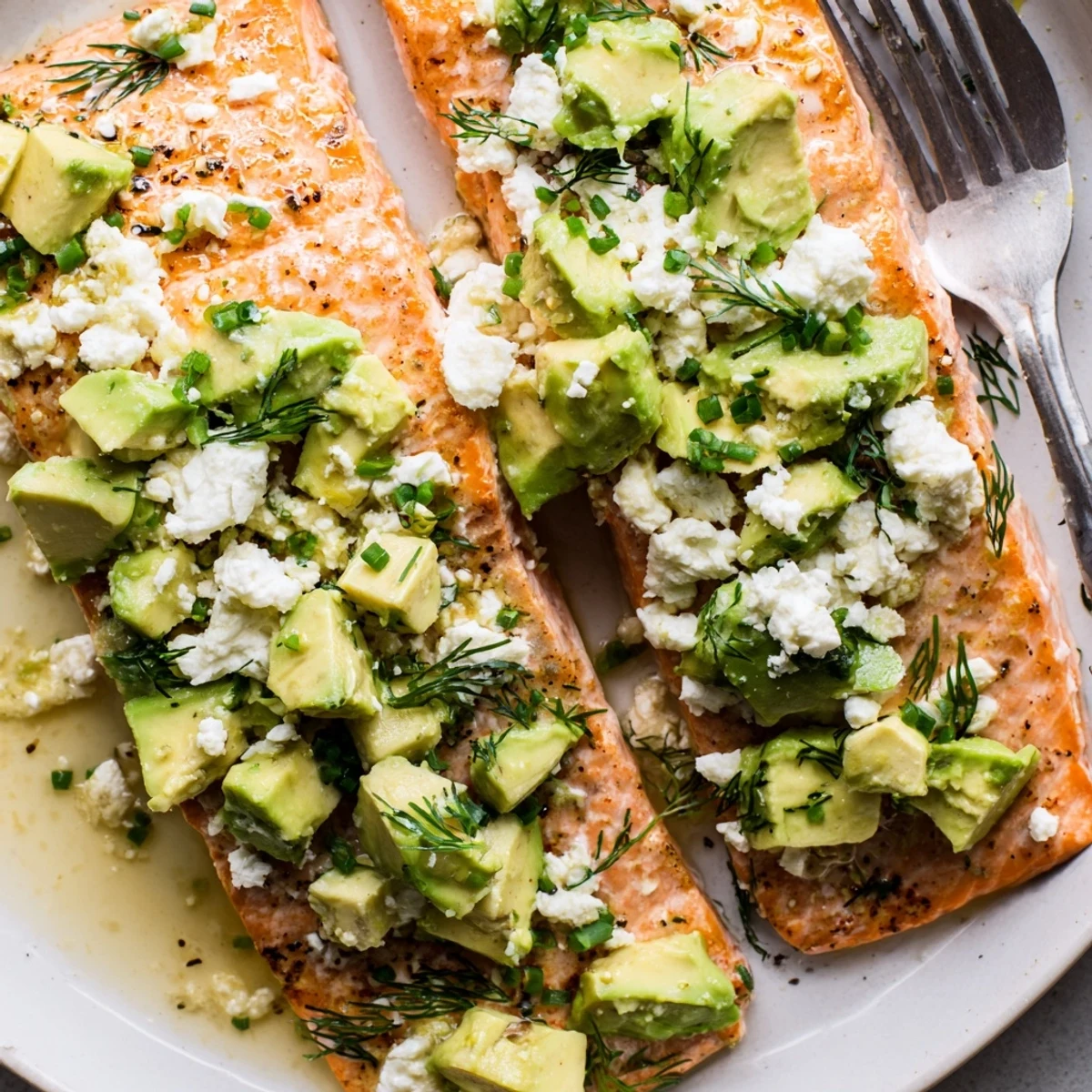 Flaky baked salmon drizzled with lemon and layered with zesty avocado-feta blend, simply irresistible!