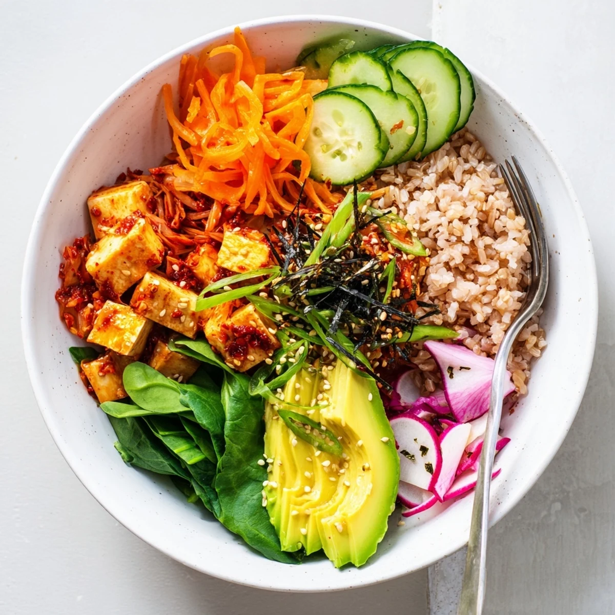 A colorful Fermented Vegetable Bowl topped with creamy avocado and tangy kimchi.  