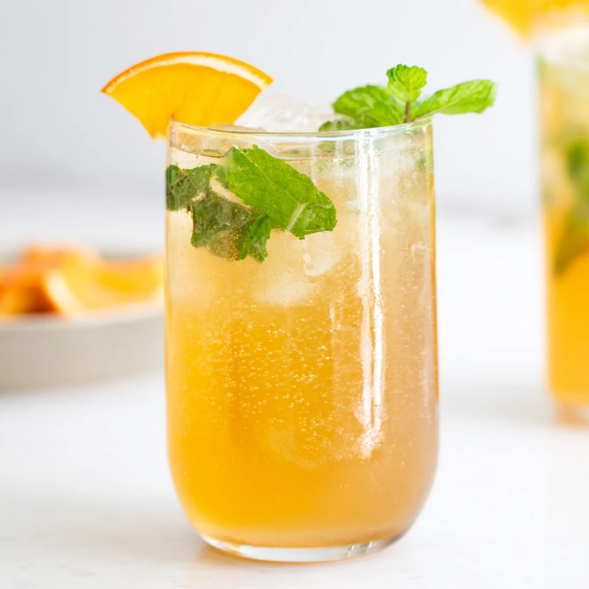Refreshing probiotic soda mocktail with mint and citrus, perfect for summer gatherings.  