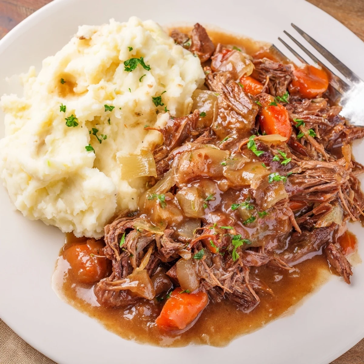 Slow Cooker Pot Roast with Mashed Potatoes served with rich brown gravy and fresh parsley.  