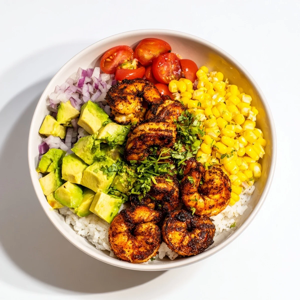 Sizzling blackened shrimp bowls, loaded with creamy avocado corn salsa and fresh cilantro, a delicious Southwestern meal.
