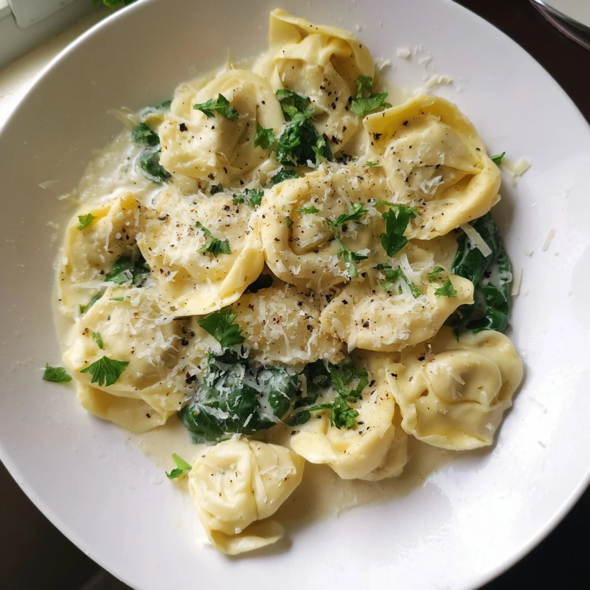 Creamy Spinach Alfredo Tortellini, a comforting Italian pasta dish with rich, creamy sauce and fresh spinach.