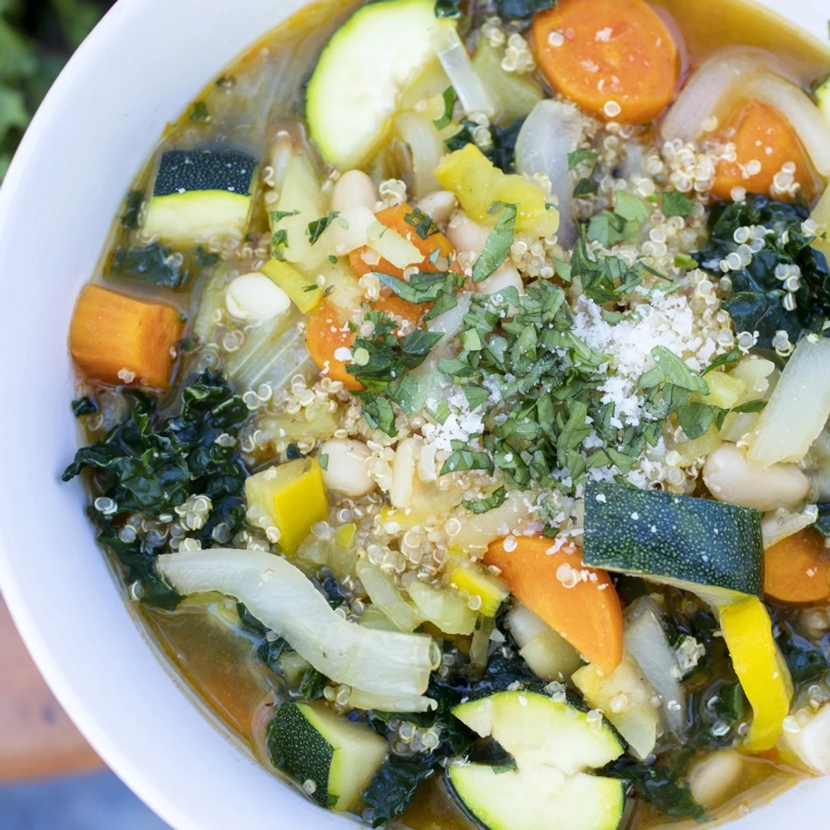 Close-up of a rustic, hearty Minestrone with Quinoa, showing colorful vegetables and beans.