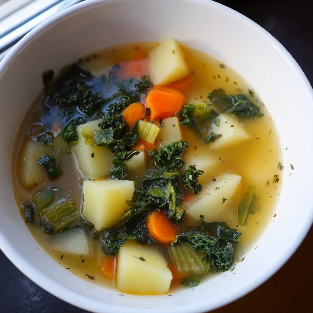 Hearty Vegetarian Potato-Kale Soup, a comforting blend of potatoes, kale, vegetables ready to serve.