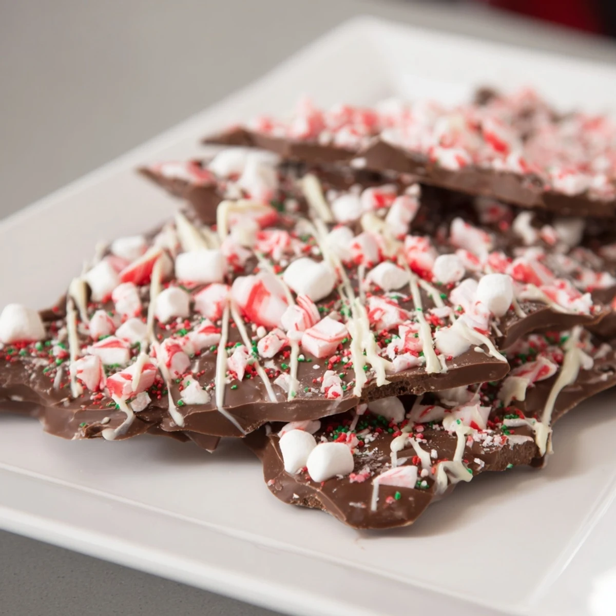Swirled white chocolate and marshmallow top this homemade Hot Chocolate Bomb Bark, ready to share.