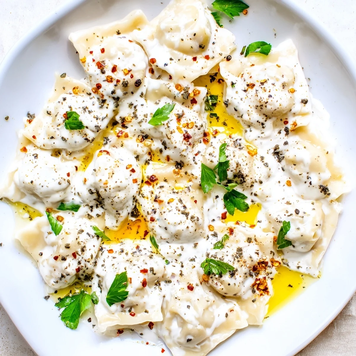 Close-up photo of freshly-made Turkish Cheesy Manti dumplings, overflowing with cheesy flavor and delicious sauce.