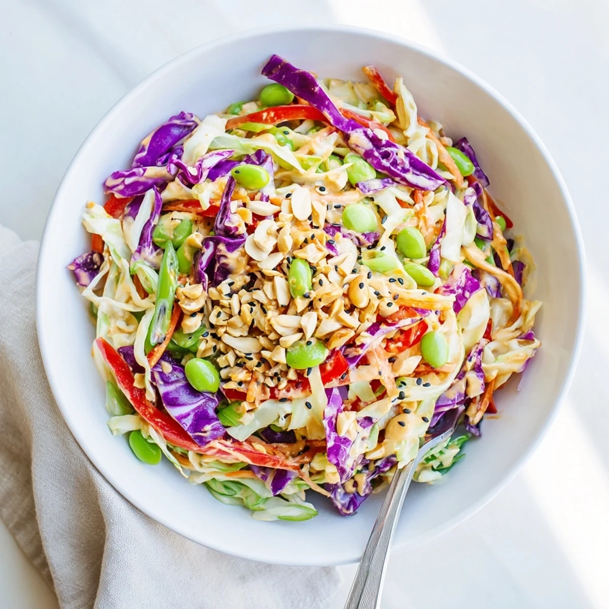A close-up view of Crunchy Thai Peanut Salad topped with chopped peanuts and fresh cilantro, perfect for a light lunch.  