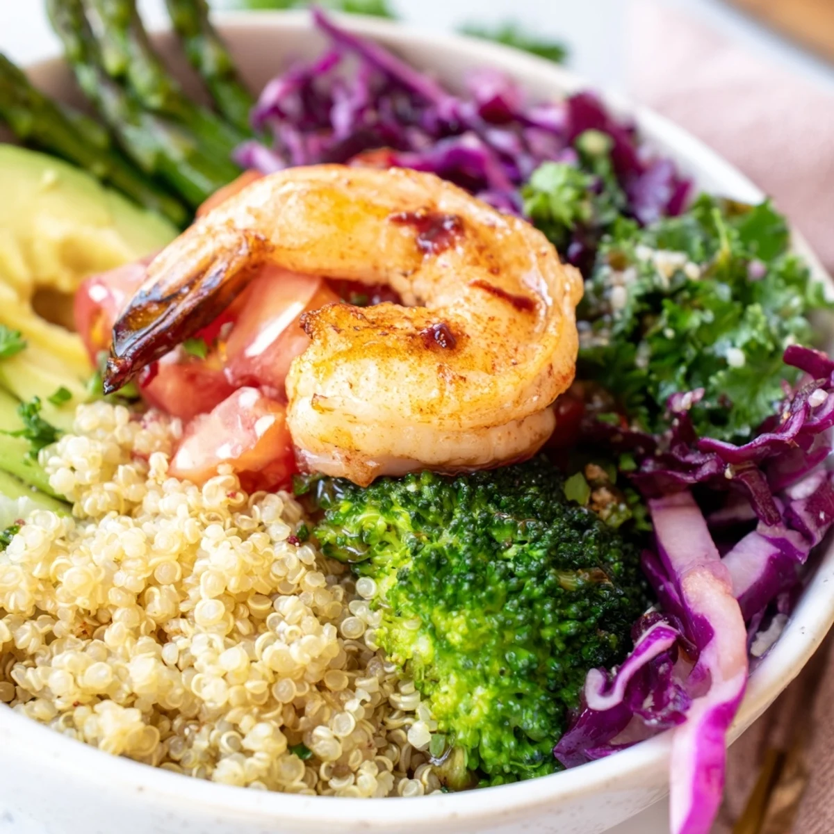 A vibrant Detox Buddha Bowl with Shrimp and Quinoa topped with crisp broccoli, asparagus, and creamy avocado slices.