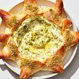 Golden, flaky pastry surrounds a creamy, green star-shaped pesto dip in this delicious appetizer.