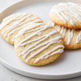 Freshly baked Holiday Cookies with Icing Drizzle, showcasing perfectly round shapes and a delightful, sweet taste.