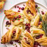 A close-up of the beautiful, star-shaped Cranberry Christmas Star, with glistening cranberries and flaky pastry.
