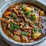 A hearty ladle of Black-Eyed Pea Stew with Chefs Touch showcases colorful potatoes and carrots.