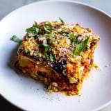 Steaming hot Eggplant Parmesan Lasagna with crispy fried eggplant, perfect for a cozy, delicious dinner.