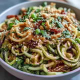 Healthy Easy Zucchini Noodle Stir-Fry with Peanut Sauce, packed with crisp veggies and creamy peanut sauce in a vibrant, colorful bowl.