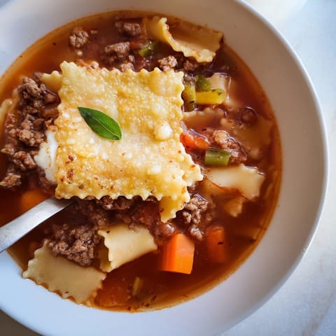 Comforting bowl of Lasagne Soup highlighting layered flavors and creamy textures.  
