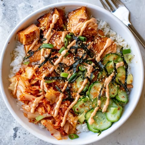 Flavorful crispy salmon served over golden rice with crunchy garlic and sesame seeds.  