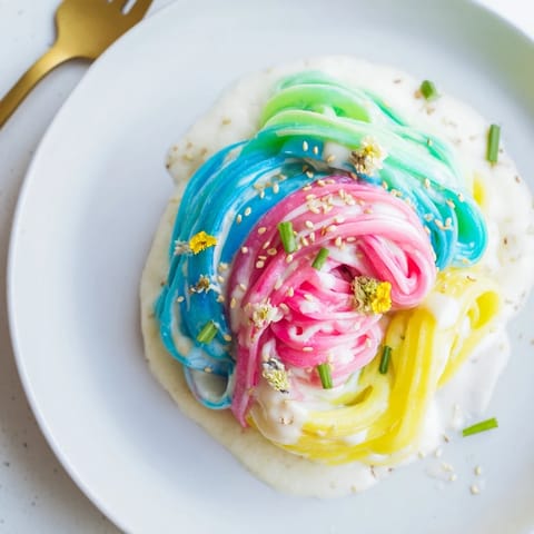 Creamy Neon Noodle Cloud served in a whimsical bowl, perfect for kids' parties.  