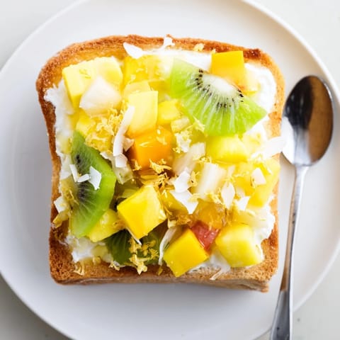 Golden-baked Yogurt-Custard Toast 2.0, drizzled with honey and vibrant fruit toppings.  