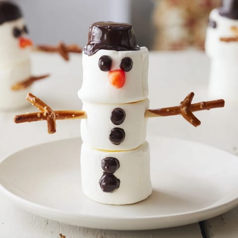 A close-up of the finished Marshmallow Snowman Stick Arrangement, ready for a winter dessert platter.