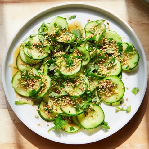 Close-up of a bowl showing the refreshing Tangy Shaken Asian-Style Cucumber Salad, ready for serving.