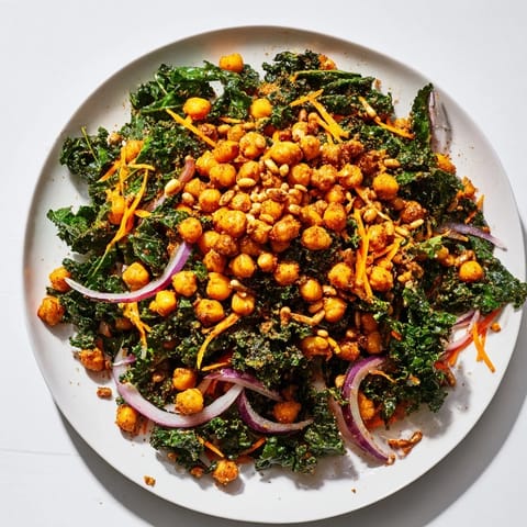 Crispy golden roasted chickpeas topping a bowl of beautifully prepared kale salad, ready to enjoy.