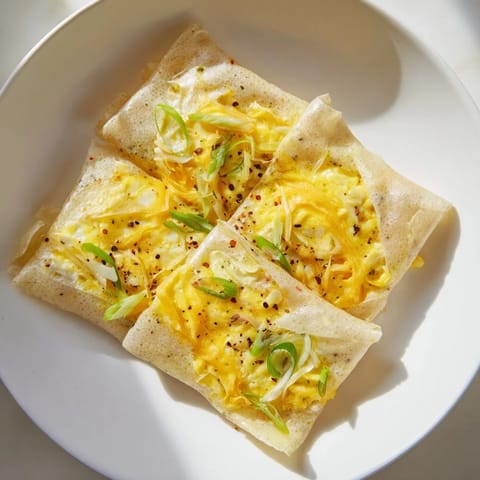 This close-up showcases warm, cheesy Rice Paper Egg & Cheese Folds glistening, perfect for breakfast.
