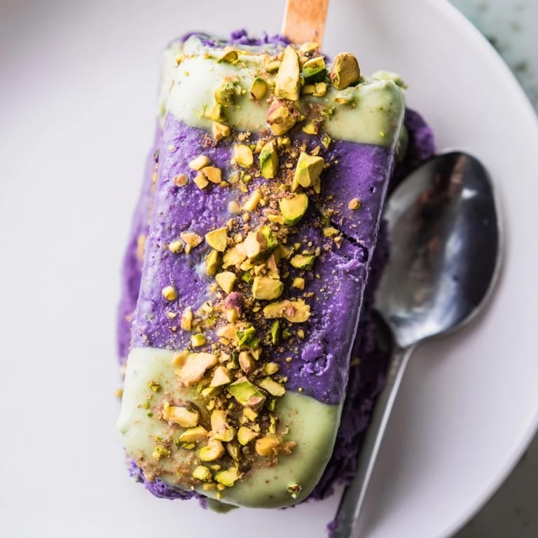 Delicious ube and pistachio ice cream bars drizzled with sweet condensed milk, irresistible treat.