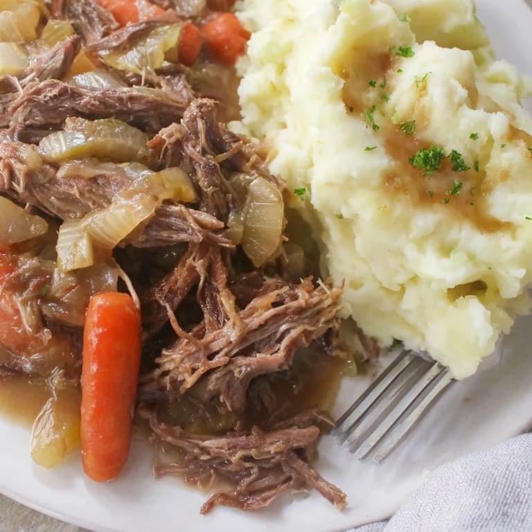 Comforting Slow Cooker Pot Roast with Mashed Potatoes, a steaming, savory dinner delight.  
