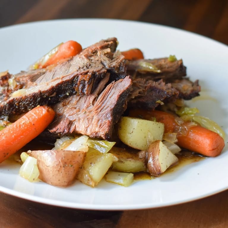 Forkful of juicy Pickle Brine Pot Roast over mashed potatoes, showcasing the deliciousness of this meal.