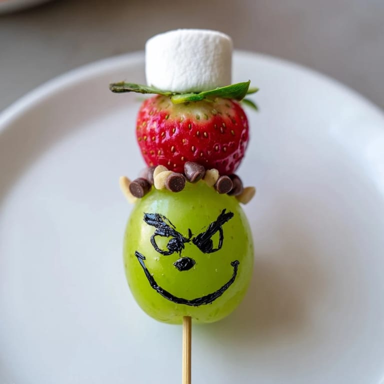 Get creative making this Grinch Snack! Grapes, marshmallows, and sprinkles complete this charming edible art!