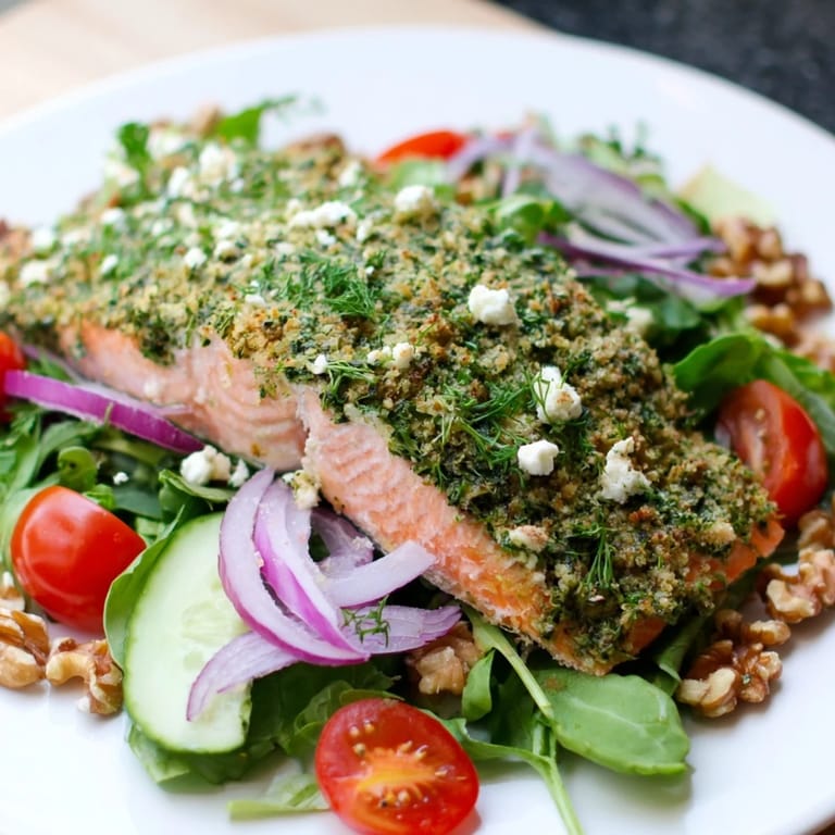 Golden herb-baked salmon fillets atop a fresh salad, featuring the satisfying herb-crusted salmon.