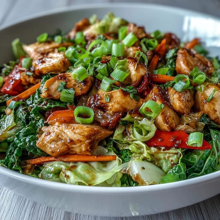 Savory Chicken Cabbage Stir-Fry served hot over fluffy rice, garnished with fresh green onions.